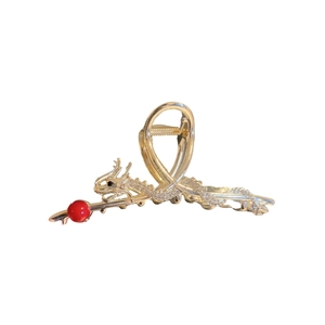Golden Chinese dragon hair claw clip with red pearl bead on a clean white background