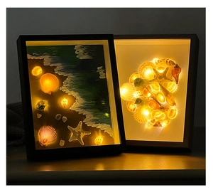 Detail of seashell shadow box with LED lights showing marine decor and wave art