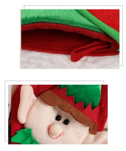 Macro detail of cartoon Christmas elf gift bag with red hanging strap and embroidery