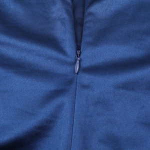 Detail of the high-quality invisible zipper on a navy blue satin formal dress