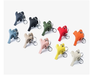 Close-up of cute leather elephant keychains in various vibrant colors with metal rings