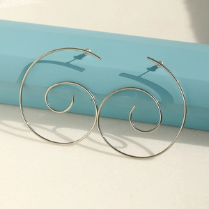 Minimalist spiral hoop earrings in silver finish on a clean aesthetic display base