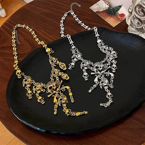 Gothic skull and crossbones tassel necklaces in gold and silver metal finishes