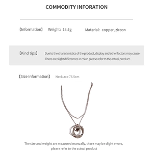 Detail view of double ring pendant necklace in rose gold finish with zircon inlay