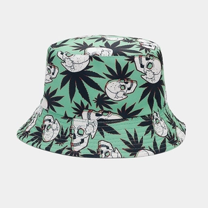 Detailed pattern of white skulls and green leaves on mint green cotton bucket hat