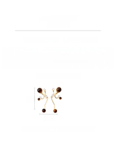Detailed view of vintage tiger eye drop earrings with cubic zirconia and copper base