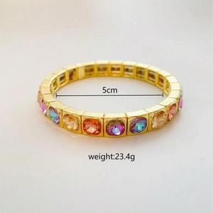 Detail shot of colorful square crystals on a gold elastic bracelet with 5cm diameter