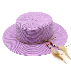 Flat top purple straw boater hat with bohemian feather and bead decoration