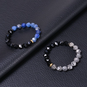 Detail of 10MM faceted blue agate and obsidian beads with gold zircon spacer ring