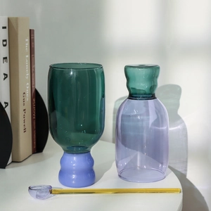 Minimalist bicolor high borosilicate glass cup and bottle set with yellow stirring spoon