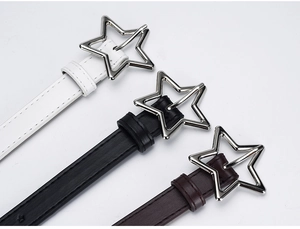 Detail of star-shaped silver buckles on slim white, black, and brown fashion belts