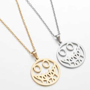 Detail of round hollow sun flower pendants in gold and silver stainless steel finish