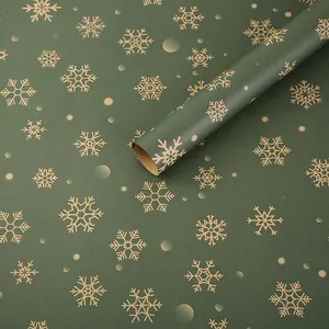 Dark green Christmas wrapping paper rolls with elegant gold snowflake patterns