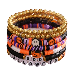 Close-up of Halloween beaded bracelets with BOO lettering, pumpkin and skull charms