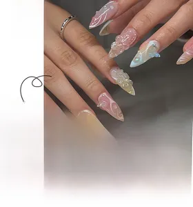 Detail of almond-shaped press-on nails with 3D floral butterflies and pink-blue gradient