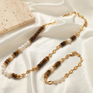 Tiger eye and pearl beaded necklace set on beige silk with stone prop