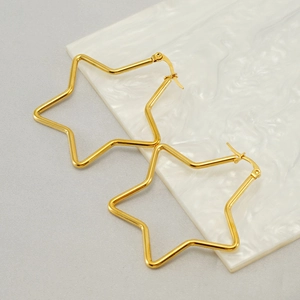 Minimalist 18k gold plated stainless steel hollow star earrings on marble surface