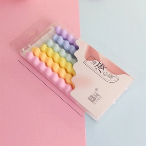 Detail view showing 7.5cm height of 6 colorful spiral birthday candles in packaging.