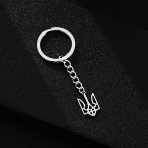 Polished silver trident pendant keychain made of durable stainless steel on black background