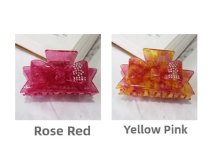 Detail of rose red and yellow pink marble hair claws with rhinestone bow decorations