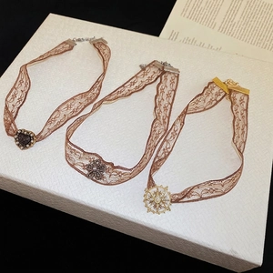 Vintage lace choker set with heart and flower pendants and shimmering rhinestones