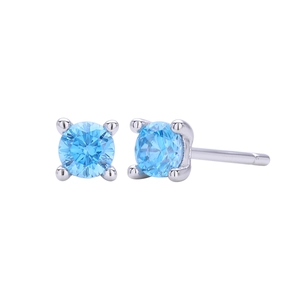 Detailed macro view of 925 silver stud earrings with blue round-cut four-claw crystals