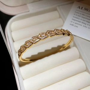 Macro detail of gold plated hexagon bangle with cubic zirconia pavé in a jewelry box