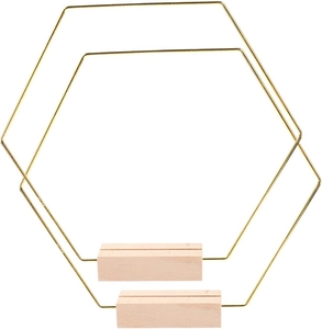 Detail of hexagonal gold metal frame with wooden base stand for wedding table decor