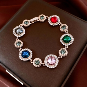 Close-up of vintage bracelet with colorful gemstones and diamond accents in rose gold