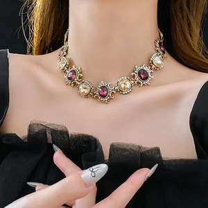 Vintage gold baroque necklace with purple gemstones and crystals on a model