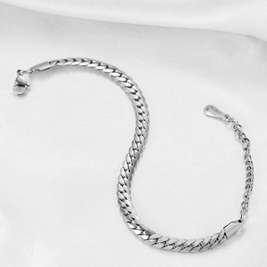 Classic 6mm silver stainless steel Cuban link bracelet on elegant white silk background