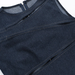 Detail of dark blue denim top featuring sexy cutout design and metal zipper closure