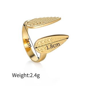 Detail view of gold open ring with wing texture showing 2cm height and 1.8cm width specs