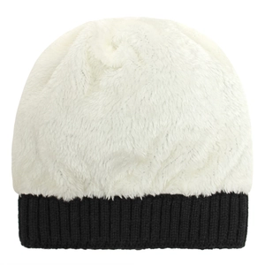 Close-up of baby winter knit hat with fluffy white faux fur and black ribbed hem detail