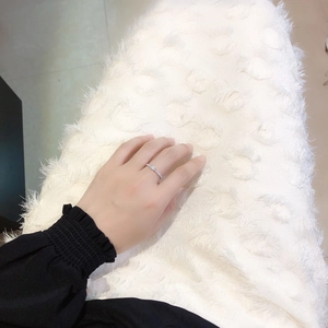 Minimalist silver square cubic zirconia ring on model hand with luxury velvet background