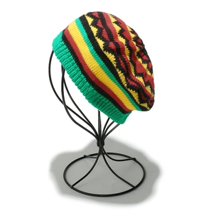 Detail view of handmade crochet Rasta beanie with red yellow green stripes and knit texture