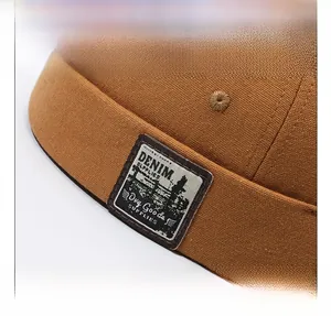 Macro shot of vintage canvas brimless cap detail with stitched denim supply woven patch