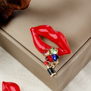 Sexy red lips crystal brooch with colored gemstones and lipstick pendant on beige box