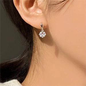 925 Sterling Silver Four-Prong Zircon Flower Stud Earrings on model for elegant look