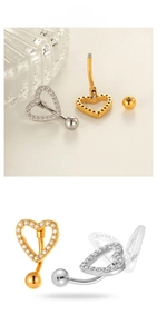Detailed view of zircon-encrusted heart belly button rings in gold and silver finishes