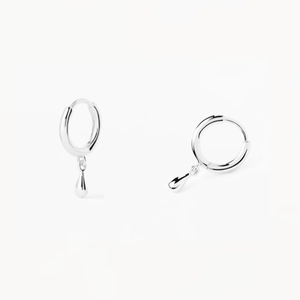 Detail of high-polish silver teardrop earrings with a minimalist hoop and smooth metallic finish