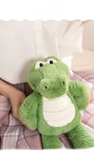 Close-up of cute green plush crocodile doll with soft long-legged design and textured belly