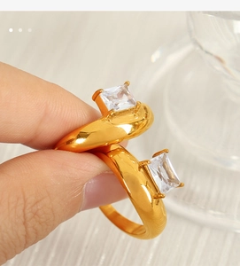 Close-up of an irregular 18k gold-plated ring with a square-cut zircon gemstone