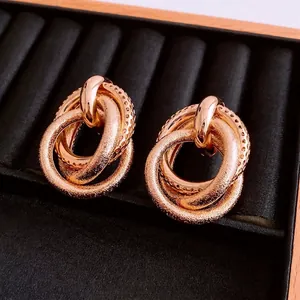 Rose gold irregular triple-intertwined stud earrings with polished and textured finish