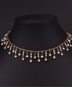Detail view of handmade freshwater pearl tassel necklace on a professional black bust