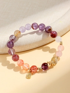 Macro detail of purple amethyst beads and gold snake pendant with lucky characters