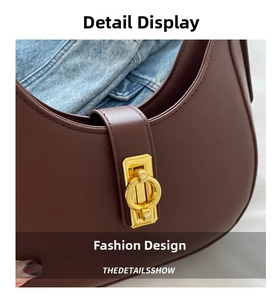 Detailed close-up of dark brown leather hobo bag with a gold circular metal buckle