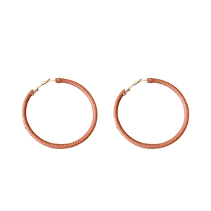 Minimalist round geometric hoop earrings with brown leather texture and golden metal accents
