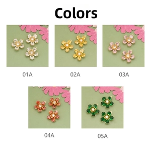 Detailed view of 18k gold plated five-petal flower pendants with colorful cubic zirconia