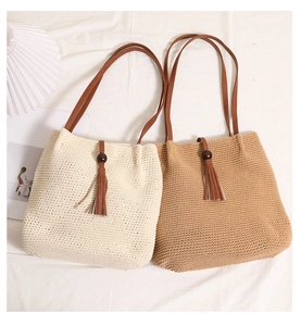 Detail of woven cotton tote bags with wooden bead tassels and premium leather straps